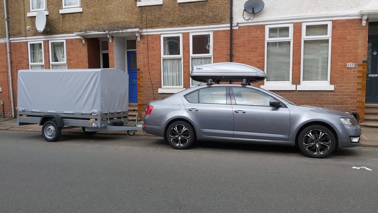 A couple decides on a meal from a food truck menu in New York City, featuring various snacks.